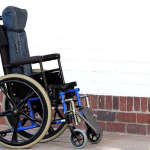 A wheelchair with a cushion.
