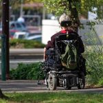 Person in a motorized wheelchair.