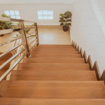 Wooden stairs with a handrail.