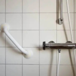A handrail in an accessible bathroom.